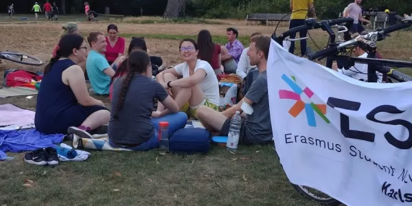 People sitting next to the ESN-flag