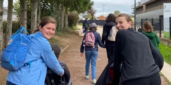 Students on a walk with children with disabilities.