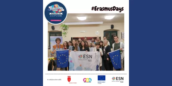 The picture shows a group of people smiling at the camera. The people in the front row are holding ESN Trieste's flag (in the centre) and two EUropean Union flags (on the sides). At the bottom of the picture we can find the logos of the different institutions and organisations that worked together to realise this event.