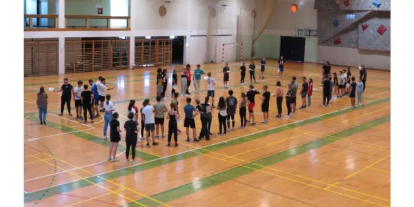 students playing frisbee in the gym