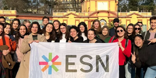 International students inside Giardini Ducali with ESN Modena flag