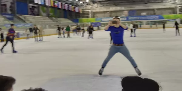 an erasmus is ice skating and taking pictures