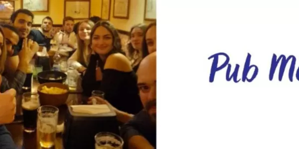 Banner of the event with a group picture inside the pub