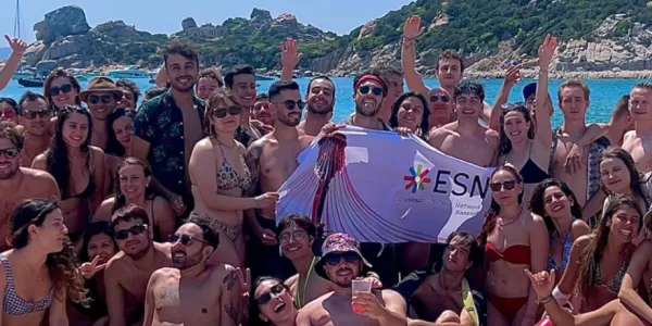 all participants on the beach holding the ESN Flag