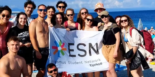 Group of Erasmus and organizer on the beach in Noli