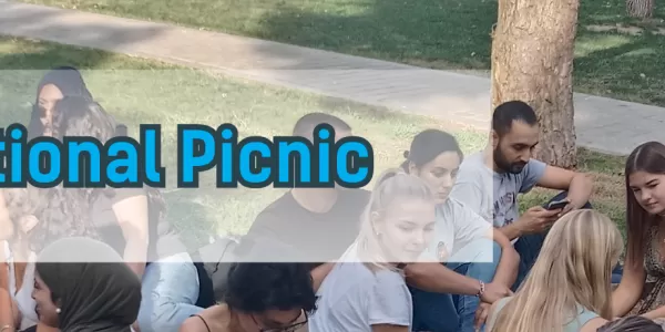 sitting on the grass with our students for our international picnic