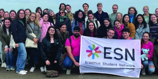 The group posing together with the ESN flag