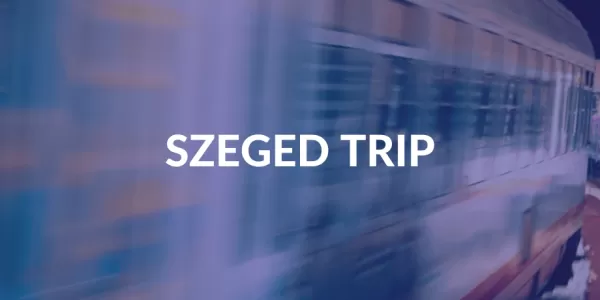 There's a train faded behind ESN's dark blue colour, Szeged trip is readable in the middle of the picture.