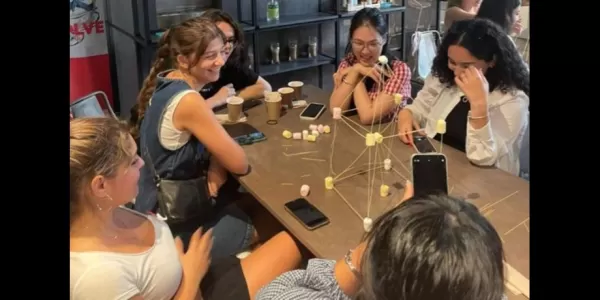 Group of international students playing a game together with noodles and marshmallows