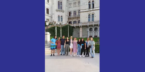 The image shows the volunteeers and erasmus students in front of Miramare Castle