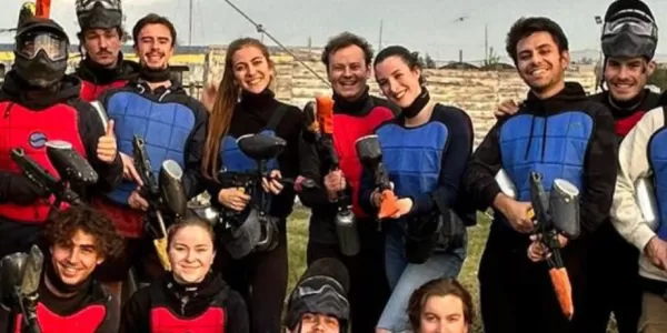 Group of international students on a paintball pitch