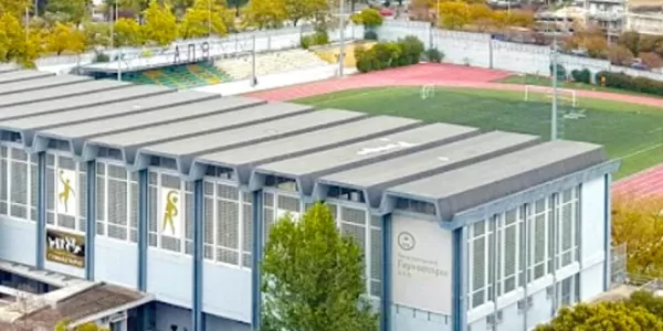 Bird's eye view of AUTH's gym, including the main building and the outdoors football courts.