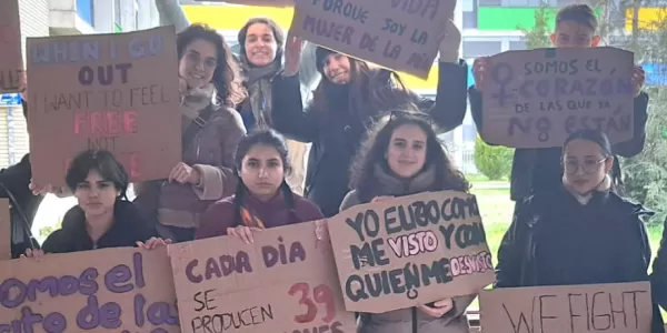 International students holding painted banners with reivindicative statements for women's rights