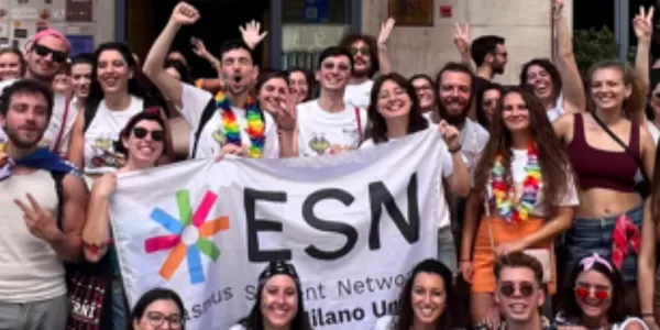 Volunteers posing with the flag of ESN MilanoUnita