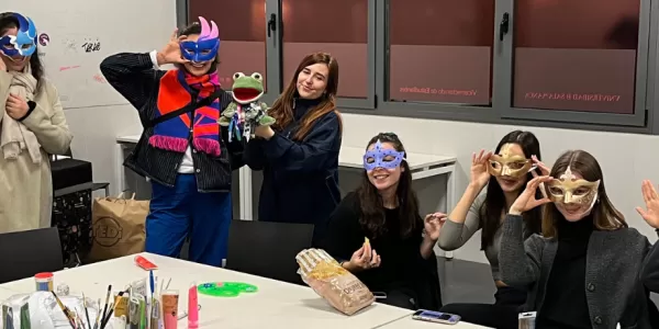 Group of international students showing off the masks they created during the activity