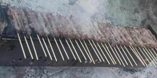 Arrosticini on the grill cooking