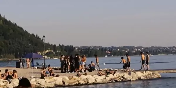 People at the beach surrounding the lake