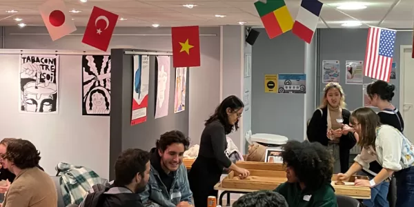 group of students talking under flags