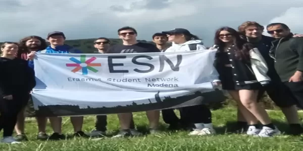 A group of people on a mountain with an ESN flag