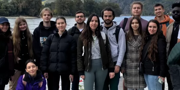 A group of internationl students posing for a group picture in Dürnstein next to the river Danube.