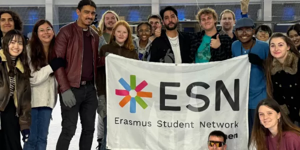 A group picture of international students and the volunteers at the ice skating rink