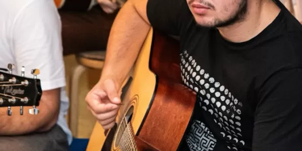 Participants and organisers playing guitars.