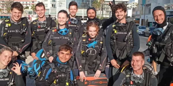 Students dressed in wetsuits with diving gear