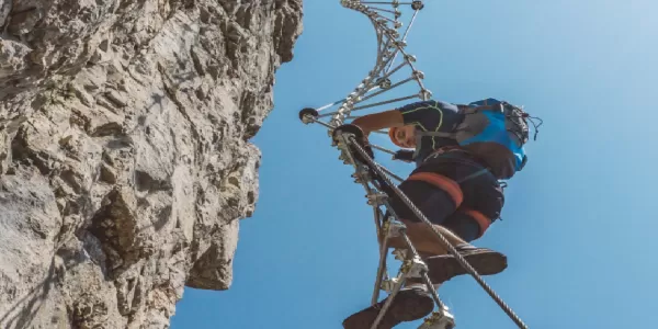 Image of a man climbing a via ferrata