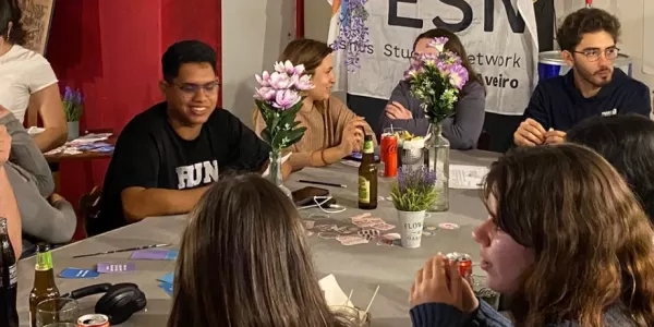 Group of international students talking inside a coffee shop.