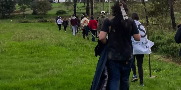 Group of international students volunteering in a forest.