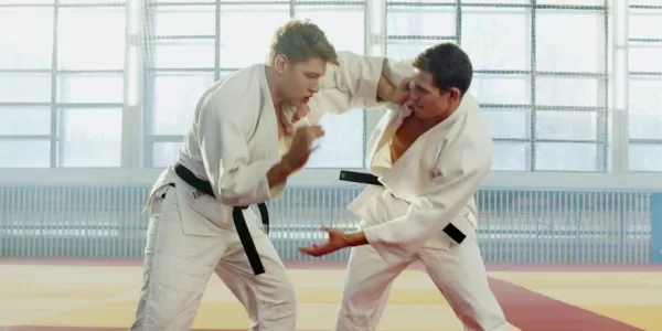 2 persons fighting in a martial art combat