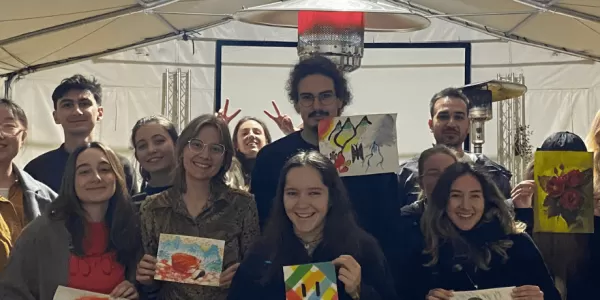group of students holding some paintings