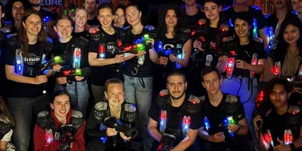 The two teams of international students before playing laser game.