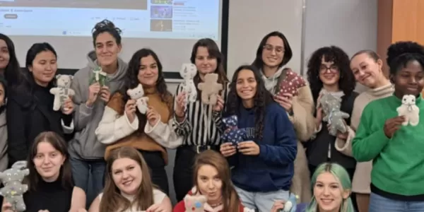 A group of students holding DIY teddy bears.