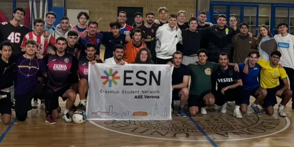 Group picture of the partecipants on the football field holding the ESN flag