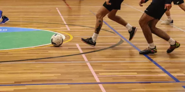 Group of international students playing futsal.