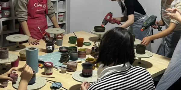 Erasmus students doing pottery