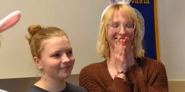 ESN volunteers wearing easter bunny ears and looking at presentation