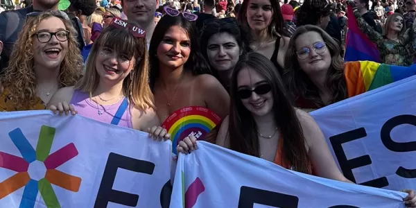 A group photo with people showing diffrent ESN Warsaw's flags after the Pride Parade.