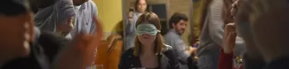 Blindfolded students having dinner