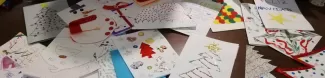 A pile of christmas postcards on a table