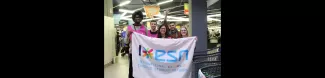 Volunteers and International students of ESN Strasbourg holding the ESN Flag in front of the supermarket where they collected food