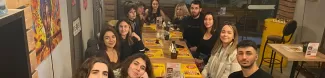 group of international and local students at a dinner
