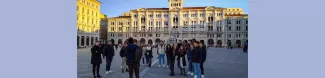 Guide in front of the group of incoming students on the Unity Square, main square of Trieste