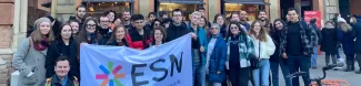 group of international students posing with the ESN Modena flag