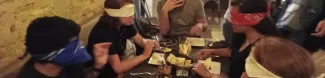 A group of International Students eating blindfolded