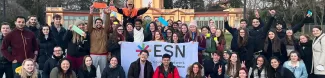 group of international students posing with the ESN Modena flag in Giardini Ducali in Modena