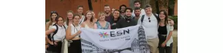 International students holding the flag of ESN Pisa.