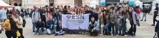 International students posing with the Flag of ESN Modena