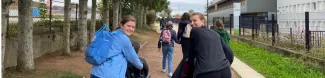 Students on a walk with children with disabilities.